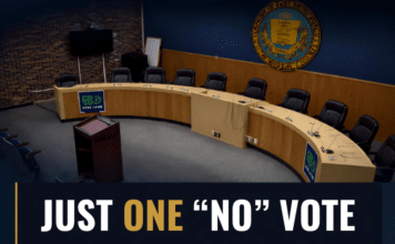 In One Year, East Brunswick Council Members Cast Just One No Vote The empty curved dais of the East Brunswick Township Council chamber beneath the township seal, overlaid with the words "Just one “no” vote — a year of East Brunswick Council votes."