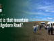 What Is That Mountain on Edgeboro Road? A group of about a dozen visitors stands on bare graded ground at the Edgeboro Road landfill beside two white shuttle buses, under a blue sky with scattered clouds. Overlaid title card reads: Eyes on EB, Part 1 of 4, What is that mountain on Edgeboro Road?