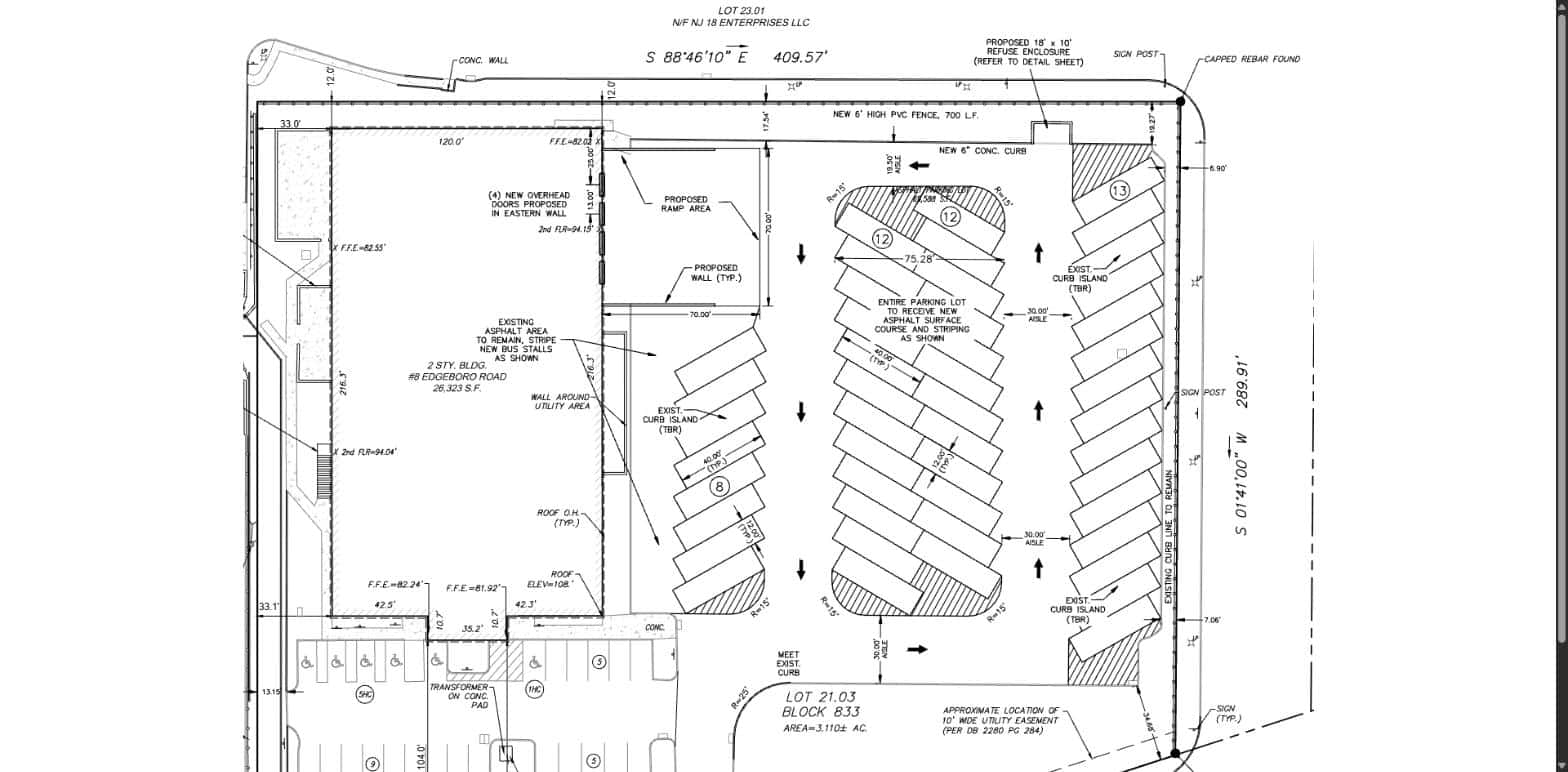 Site layout plan for 8 Edgeboro Road showing the existing two-story building, four rows of angled school bus stalls, and car parking along the front of the lot.