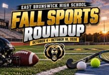 East Brunswick Fall Sports Roundup: Bears Rout Unbeaten Manalapan 6-0, Tennis Reaches Sectional Final Eyes on EB graphic reading "East Brunswick High School Fall Sports Roundup, October 4 - October 10, 2026," with a bear logo, a football helmet and football, a field hockey stick and ball, a tennis racket and ball, and a volleyball on a stadium field at sunset